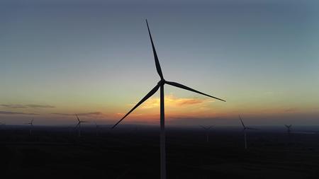 夕阳下的风力发电航拍视频视频的预览图