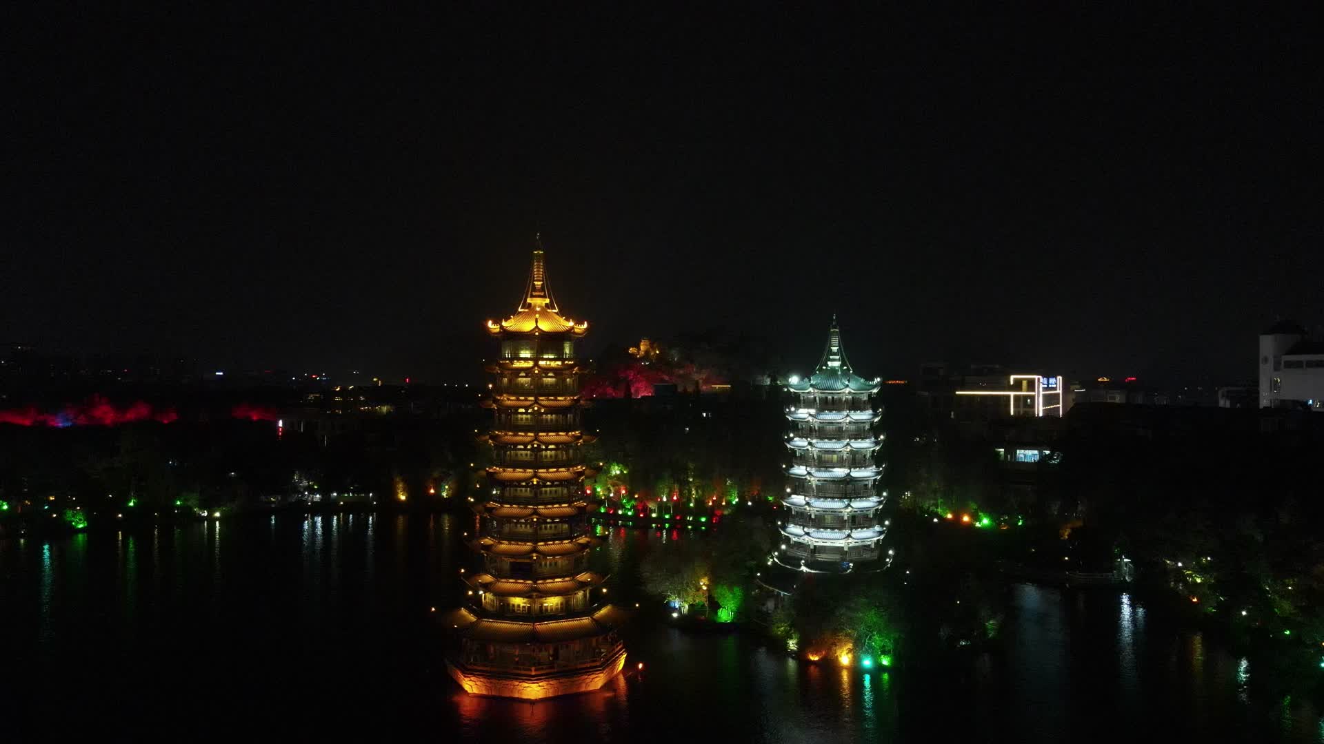 航拍广西桂林日月双塔地标建筑夜景灯光视频的预览图
