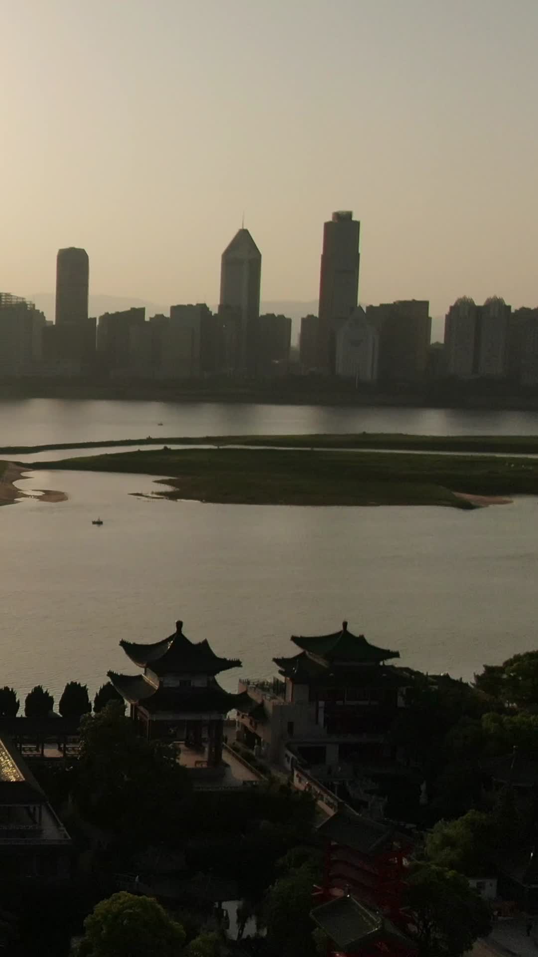 航拍江西南昌城市CBD日落晚霞竖屏视频视频的预览图