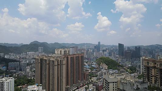 航拍贵州贵阳城市蓝天白云高楼建筑城市全景视频的预览图