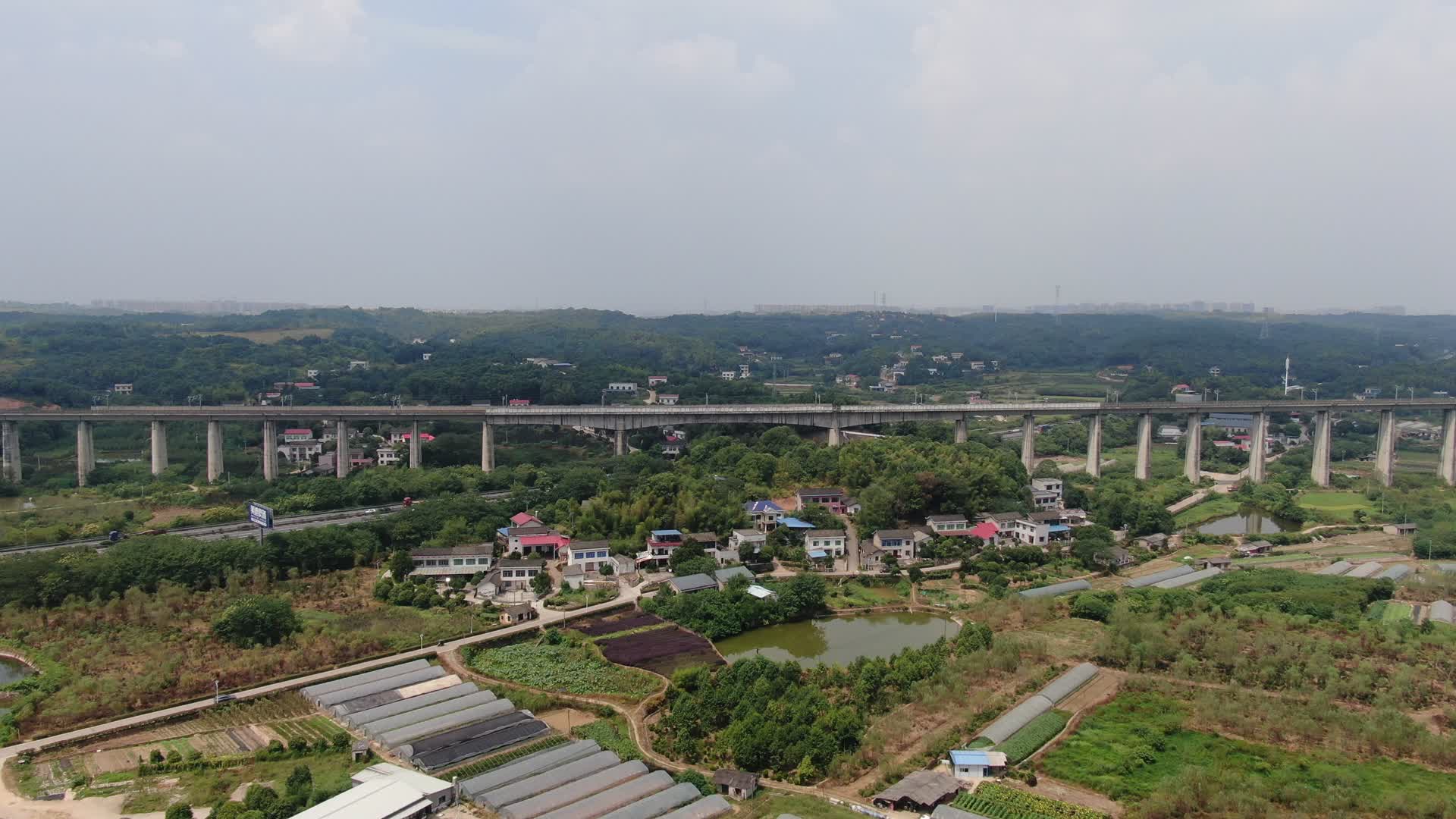 4K航拍穿过村庄的高铁高架桥视频的预览图