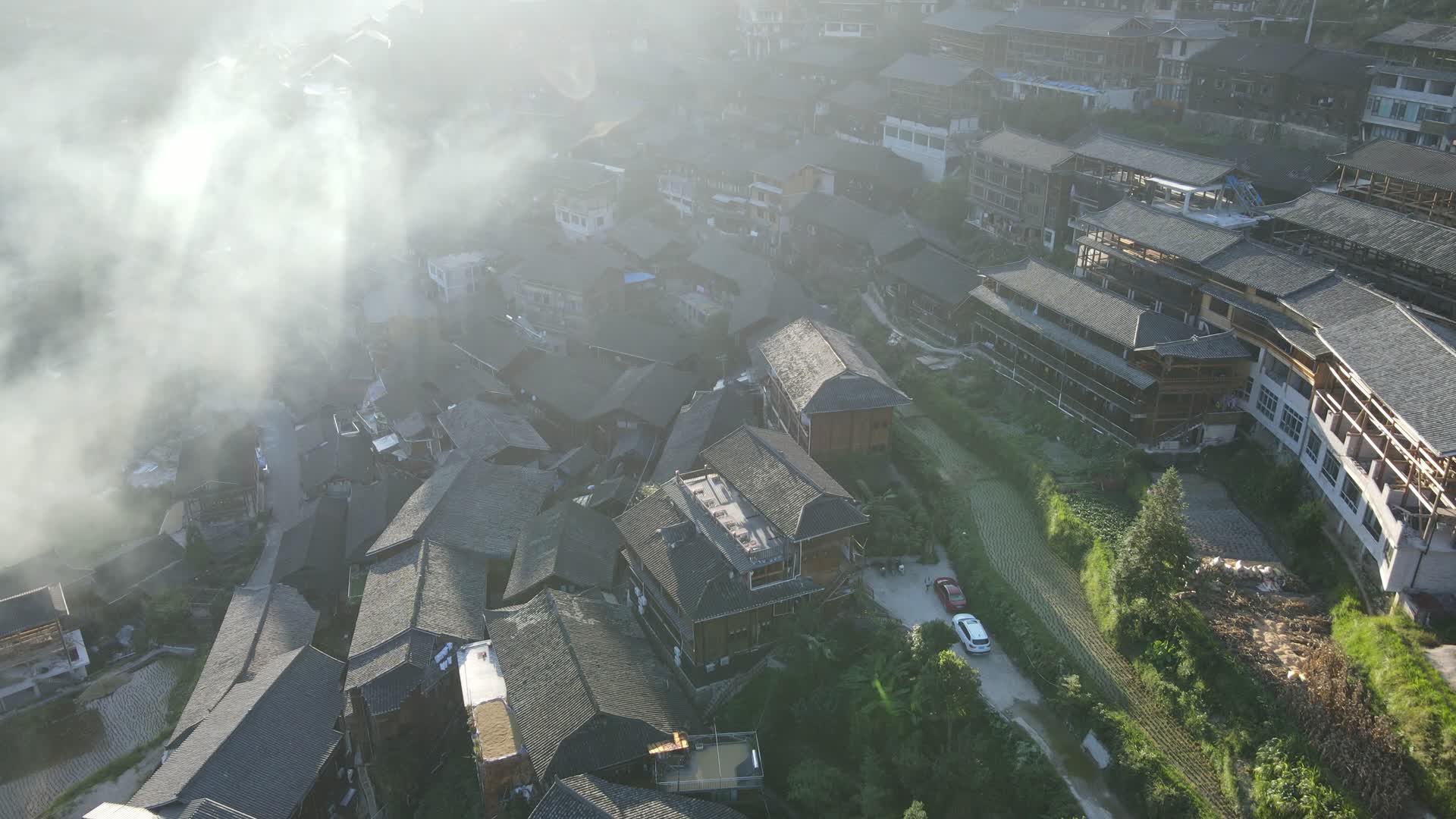 烟雾缭绕贵州千户苗寨建筑与梯田航拍视频的预览图