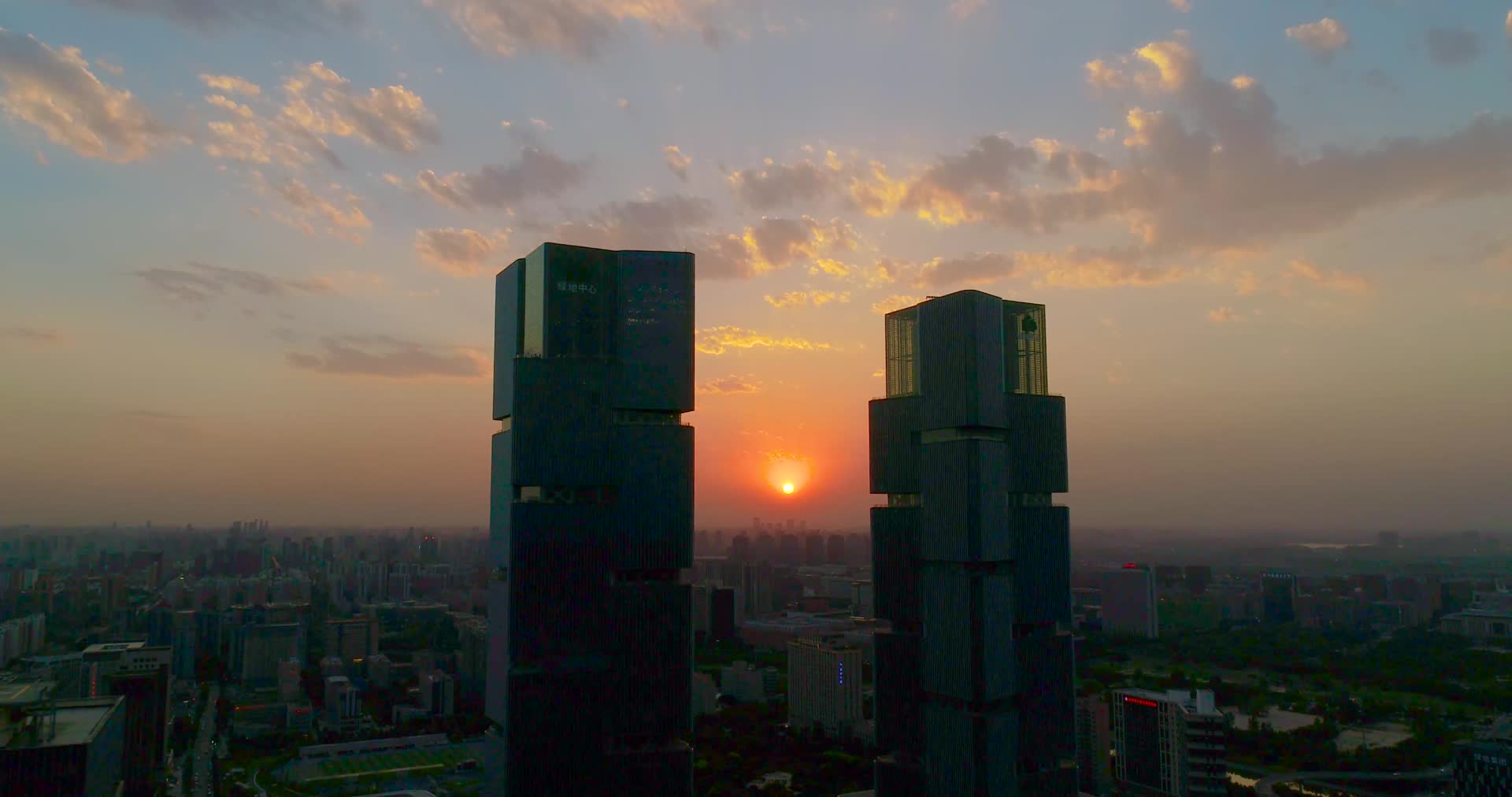 航拍郑州绿地双子塔唯美落日夕阳视频的预览图