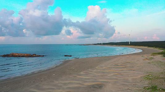 惠来县清晨大海海边海岸沙滩风车4K航拍视频视频的预览图