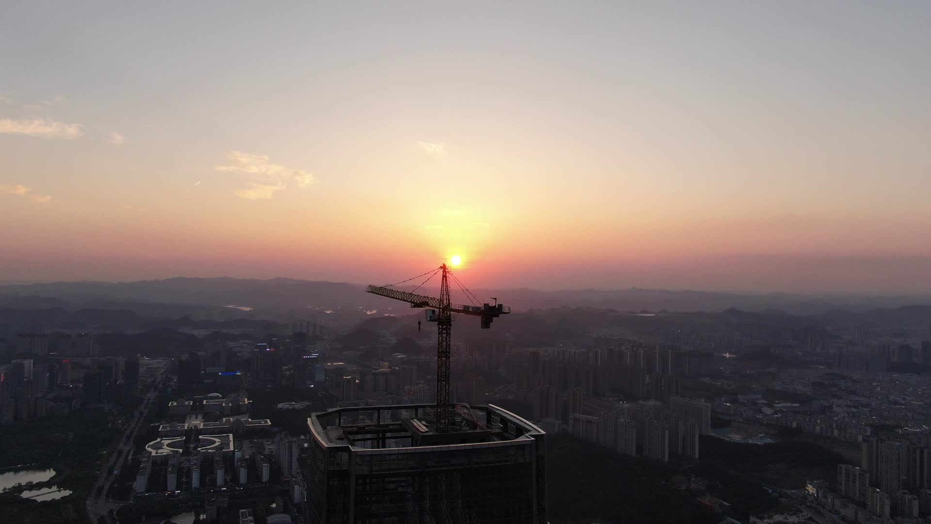 航拍高楼建筑吊塔日落晚霞夕阳视频的预览图