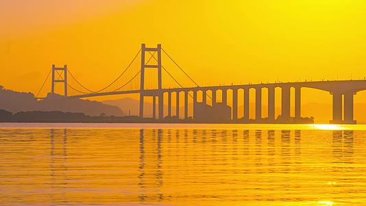 8K唯美海平面跨海大桥倒影金色光芒映照海面延时视频的预览图
