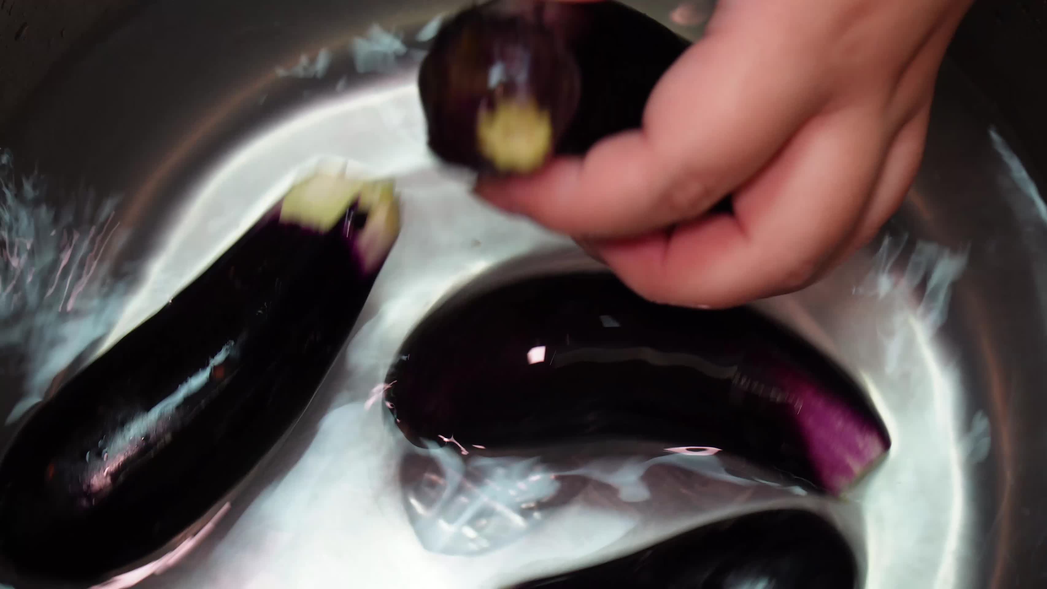水盆清洗紫茄子长茄子切滚刀块视频的预览图