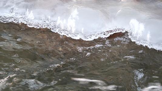 4K北方冬天阳光下河流溪流结冰解冻视频的预览图