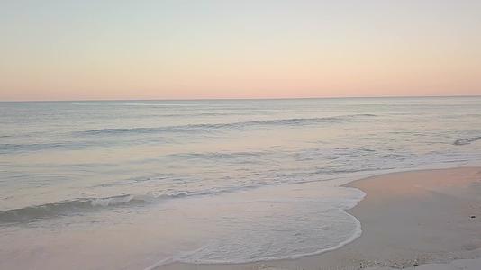 白色的浪花冲向海滩沙滩4k视频的预览图