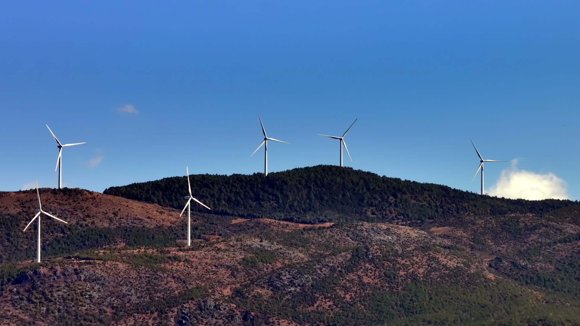 蓝天白云高山上的风力发电设施视频的预览图